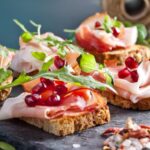 Sliced Prosciutto With Pomegranate Seeds